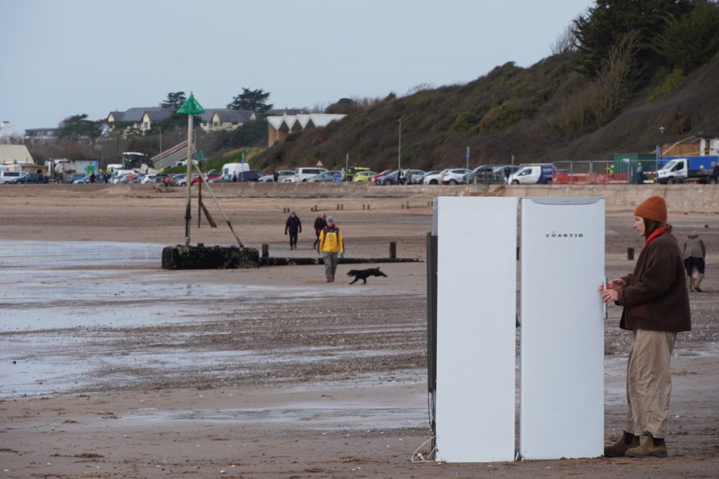 Exmouth Beach, woman looking into a freezer – Feb 2026